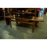 A TEAK OBLONG COFFEE TABLE WITH GLASS INSET CENTRE PANEL TO THE OBLONG TOP, CENTRE UNDERSHELF