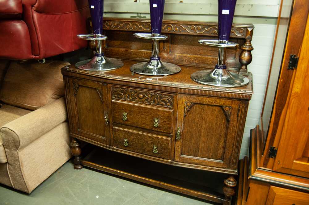 A CARVED OAK SIDEBOARD WITH CANOPY BACK