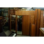 PAIR OF AUSTINSUITE TEAK WARDROBES, EACH WITH CENTRE MIRROR PANEL FLANKED BY TWO SLIDING DOORS AND A