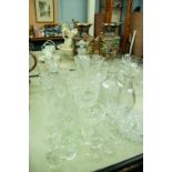 A COLLECTION OF CUT GLASS AND CRYSTAL GLASSES, VASES, DECANTERS, GRAPEFRUIT BOWLS ETC.....