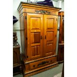 A MODERN STAINED WOOD DOUBLE WARDROBE WITH PANEL DOORS AND LARGE DRAWER TO BASE, WITH TUDOR ROSE