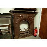 PAIR OF VICTORIAN DECORATIVE CAST IRON BEDROOM FIRE SURROUNDS WITH ARCHED RECESSES AND GRATES IN