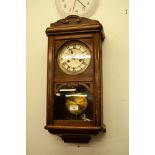 A MAHOGANY WELLINGTON TYPE WALL CLOCK