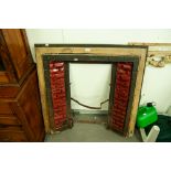 LATE VICTORIAN/EDWARDIAN CAST IRON AND FACETED RED GLAZED CERAMIC TILE INSET FIRE SURROUND