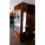 A MODERN TEAK FINISH TWO GLASS DOOR DISPLAY CABINET AND A SIMILAR CD STAND (2)