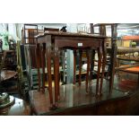 NEST OF THREE MAHOGANY COFFEE TABLES WITH INSET LEATHER TOPS AND GLASS PROTECTORS