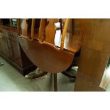 A MODERN REPRODUCTION MAHOGANY DROP-END DINING TABLE ON BALUSTER STEM AND SPLAYED QUATRE FORM