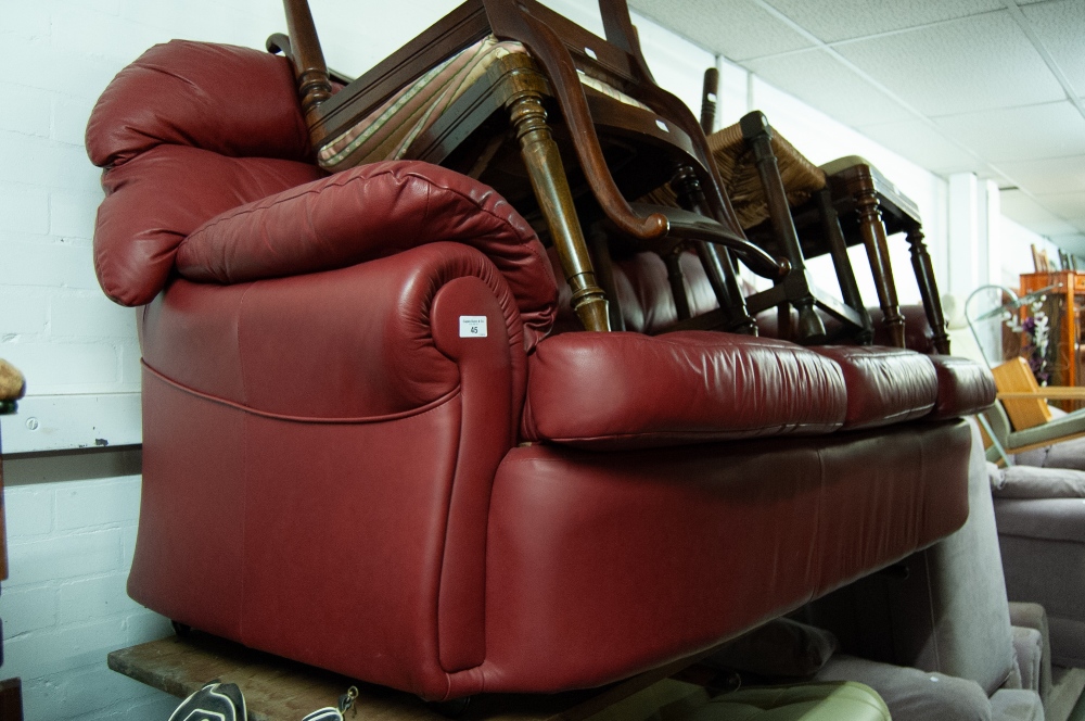 A RED HIDE THREE SEATER SETTEE