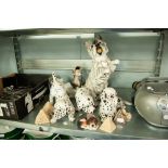 A RESIN MODEL OF A WHITE SCOTTS TERRIER IN BEGGING POSE, TWO RESIN MODELS OF SPOTTED DOGS AND 3