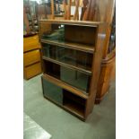 A POST WAR FOUR PART SECTION BOOKCASE WITH SLIDING GLASS DOORS