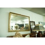 A GILT FRAMED BEVELLED WALL MIRROR AND A WOODEN TEA TRAY