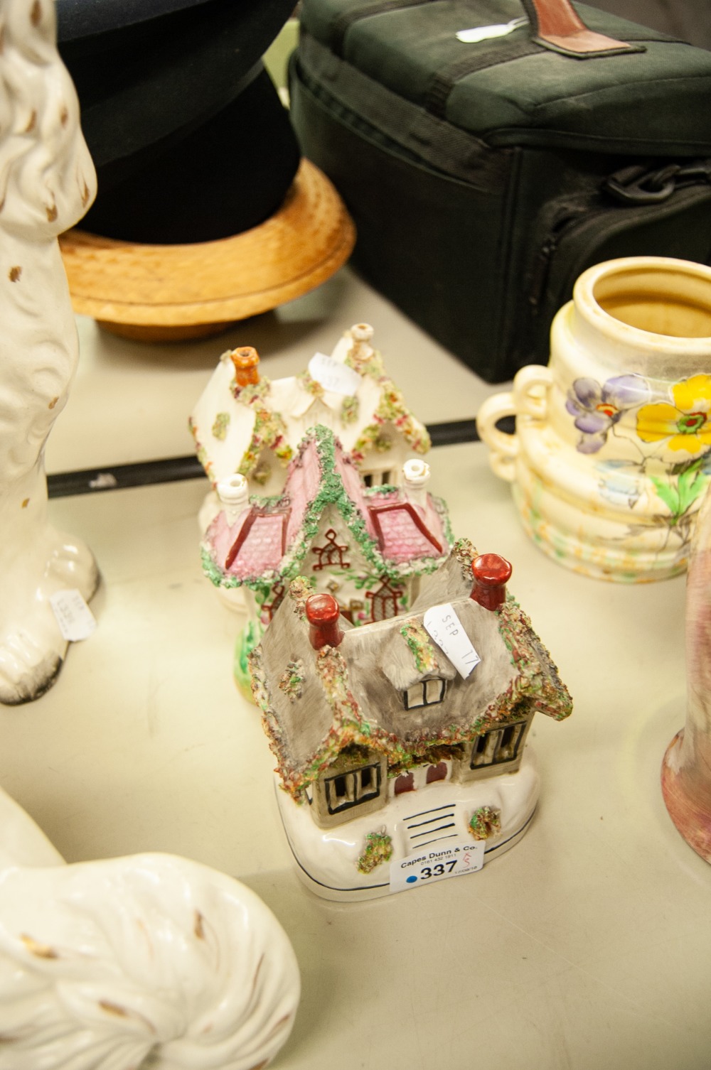 THREE NINETEENTH CENTURY AND LATER STAFFORDSHIRE POTTERY COTTAGES, including two as pastille