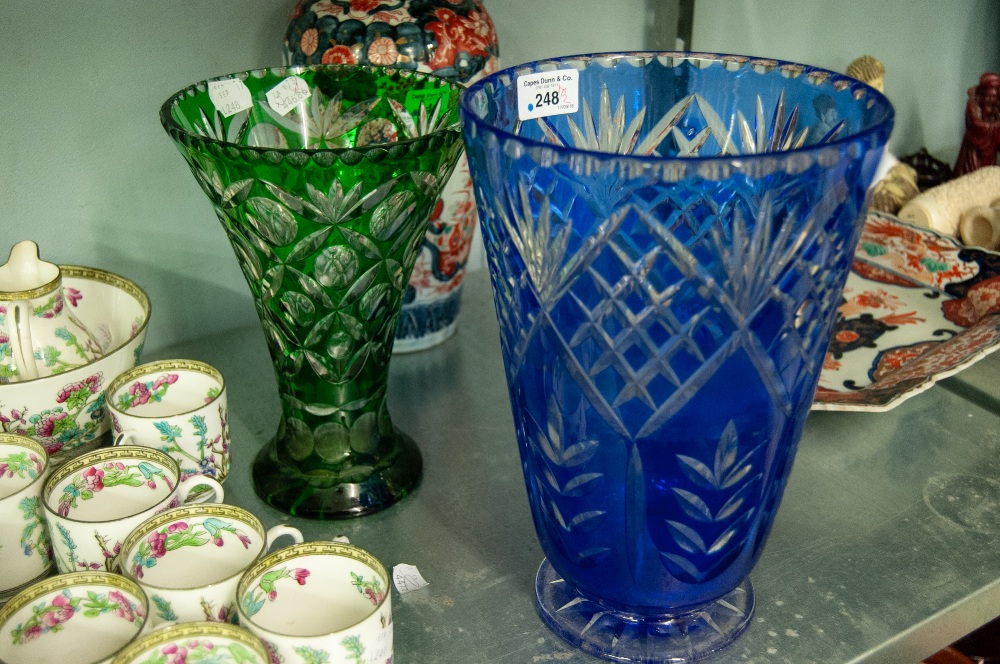 TWO BOHEMIAN FLASH CUT GLASS VASES, one of cylindrical, footed form in blue, 10 ½" (26.7cm) high,