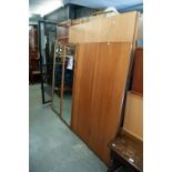 PAIR OF AUSTINSUITE TEAK WARDROBES, EACH WITH CENTRE MIRROR PANEL FLANKED BY TWO SLIDING DOORS AND A