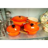 SET OF FIVE ORANGE 'LE CREUSET' PANS