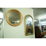 A CIRCULAR GILT FRAMED BEVELLED WALL MIRROR OF REGENCY DESIGN AND ANOTHER MIRROR