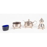 A PRE-WAR SILVER THREE PIECE CONDIMENT SET of MUSTARD POT with blue glass liner, SALT CELLAR with