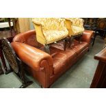 A LARGE TWO SEATER TAN LEATHER SETTEE