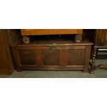 AN ANTIQUE OAK COFFER WITH THREE PANEL FRONT (A.F.)