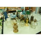 COLLECTION OF BRASS OIL LAMPS AND SHADES