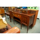 AN EDWARDIAN INLAID MAHOGANY SERPENTINE FRONT SIDEBOARD, TWO CUPBOARDS FLANKING ONE LARGE CENTRAL