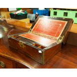 A LATE VICTORIAN ROSEWOOD WRITING BOX, HAVING A BRASS CARTOUCHE, THE LID ENCLOSING RED LEATHER AND