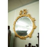 A CAST RESIN 'THE ENGLISH OAK' GILT CIRCULAR FRAMED WALL MIRROR