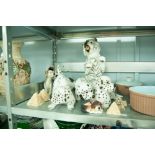 A RESIN MODEL OF A WHITE SCOTTS TERRIER IN BEGGING POSE, TWO RESIN MODELS OF SPOTTED DOGS AND 3