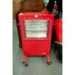 A LARGE RED CASED FLOOR STANDING HEATER ON WHEELS