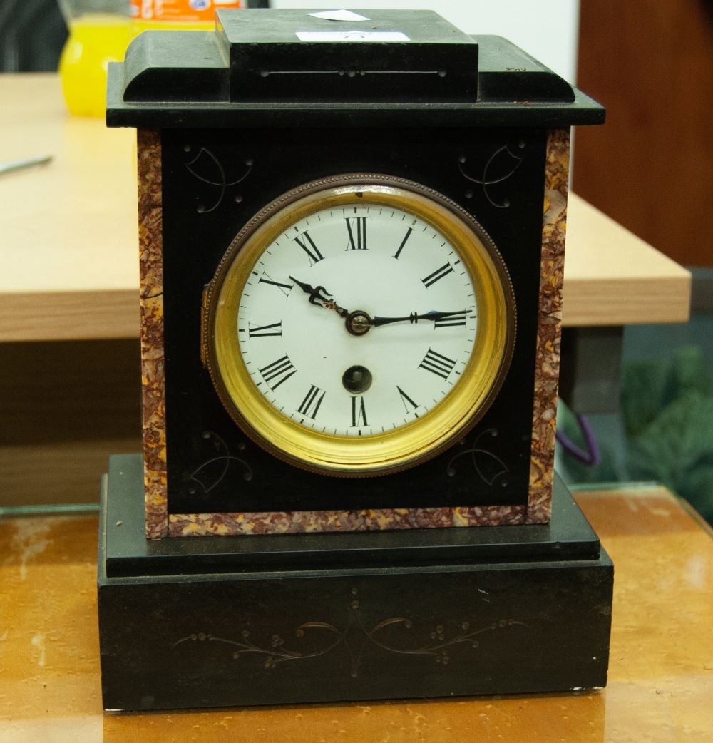 A SMALL BLACK SLATE MANTEL CLOCK