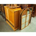 A 1980's T.V. CABINET, ALSO TWO WINDOW FRAMED WALL MIRRORS, A 1970's TEAK EFFECT OVAL COFFEE