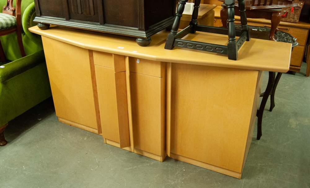 A LARGE BEECHWOOD MODERN SIDEBOARD WITH FOUR CUPBOARDS AND A SINGLE CENTRAL DRAWER WITH SHAPED TOP