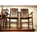 A PAIR OF REPRODUCTION OAK CARVED CHAIRS, LADDER BACKS WITH RUSH SEATS (2)