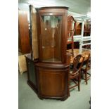 A MAHOGANY DOUBLE CORNER CUPBOARD WITH BOW FRONT