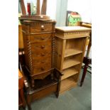 A NARROW PINE OPEN BOOKCASE WITH ADJUSTABLE SHELVES AND A NARROW CHEST OF SIX DRAWERS WITH CARVED