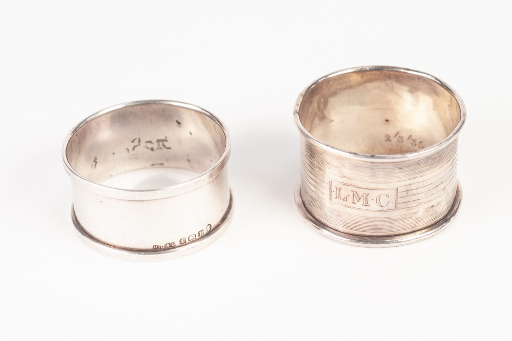 TWO SILVER NAPKIN RINGS, an odd silver TEA OR JAM SPOON, a silver souvenir SPOON and a pair of