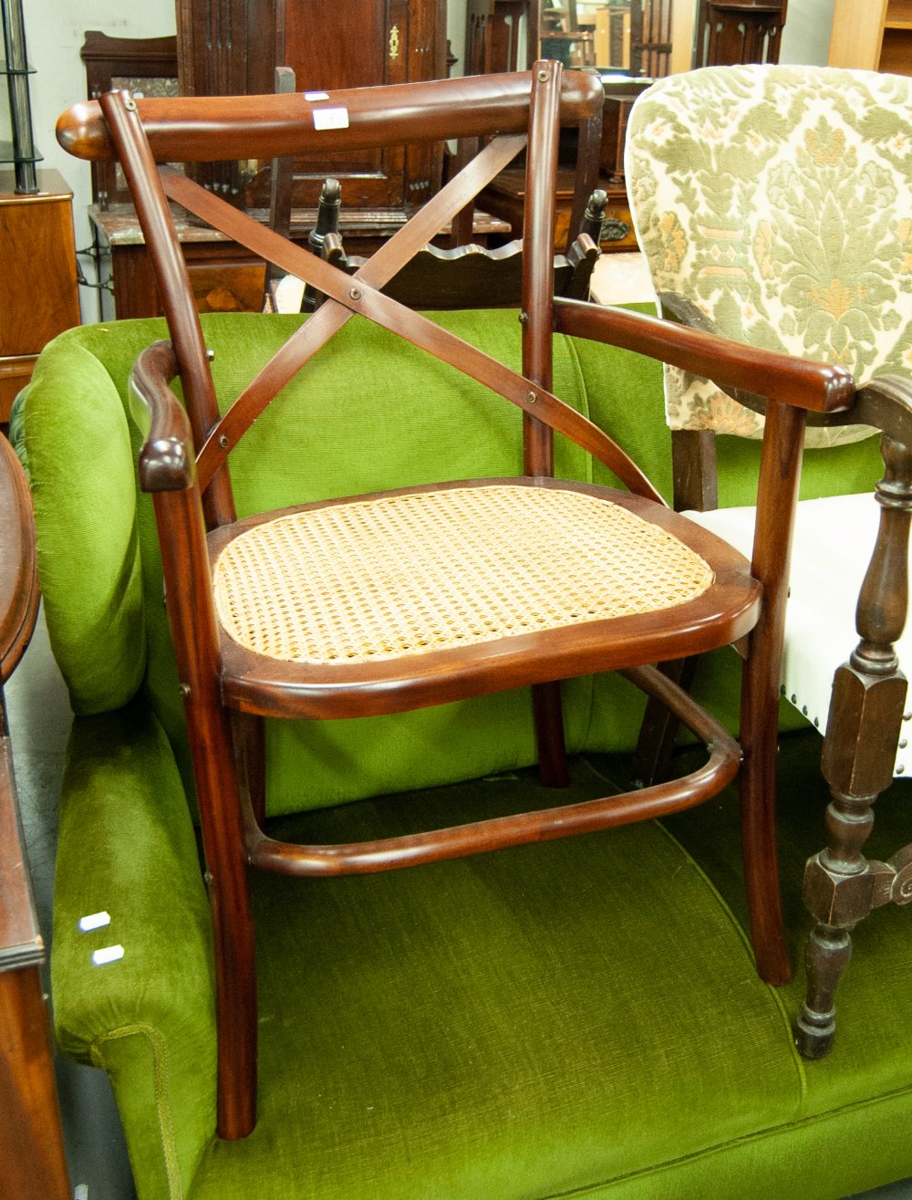 A MODERN MAHOGANY ARMCHAIR, WITH 'X' BACK, CANE SEAT, A PAD TOP STOOL, ON CABRIOLE SUPPORTS (2)