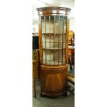 A MODERN REPRODUCTION WALNUT BOW FRONT STANDING CORNER CABINET