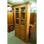 A VICTORIAN PINE TALL KITCHEN CUPBOARD WITH TWO GLAZED DOORS OVER TWO PANELS DOORS, 3'6" WIDE, 6'