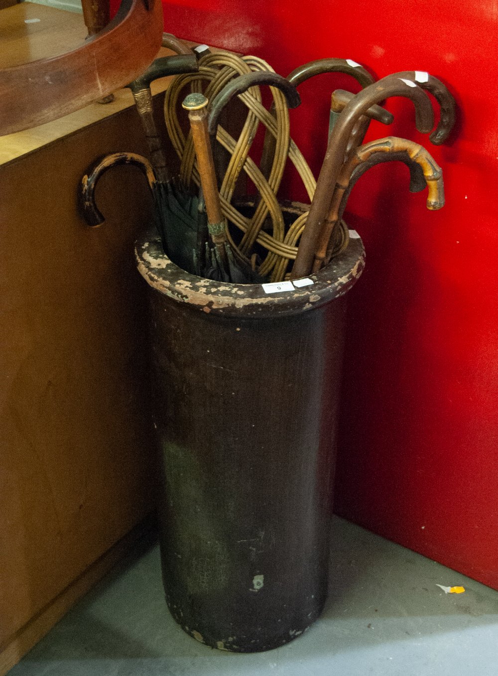 A COLLECTION OF WALKING STICKS AND UMBRELLAS, ALL CONTAINED IN A LARGE POT STAND