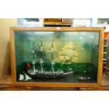 GLAZED CABINET CONTAINING THREE MODEL SHIPS WITH SEA LANDSCAPE BACKGROUND