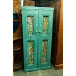 A GREEN PAINTED WOOD HANG WARDROBE WITH TWO DOORS WITH WIRE MESH PANELS, FABRIC BACKED