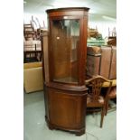 A MAHOGANY DOUBLE CORNER CUPBOARD WITH BOW FRONT