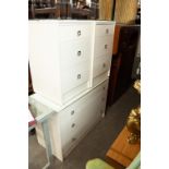 A WHITE MELAMINE CHEST OF THREE LONG DRAWERS AND A PAIR OF MATCHING THREE DRAWER BEDSIDE CABINETS