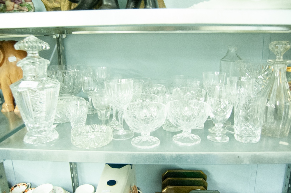 A COLLECTION OF CUT GLASS AND CRYSTAL GLASSES, VASES, DECANTERS, GRAPEFRUIT BOWLS ETC.....