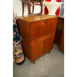 A CIRCA 1970's TEAK COCKTAIL CABINET, ANOTHER TEAK COCKTAIL CABINET AND A TEAK BUREAU (3)