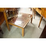 A MAHOGANY OBLONG COFFEE TABLE WITH DECORATIVE BLACK GLASS TOP DEPICTING TERRESTRIAL GLOBES, BRASS