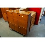 A MID TWENTIETH CENTURY LIGHT OAK CHEST OF FOUR DRAWERS, A TEAK BOOKCASE WITH TWO GLASS SLIDING