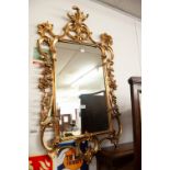 AN OBLONG WALL MIRROR IN ORNATE ROCOCO GILT FRAME (2)