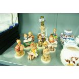 NINE W. GOEBEL (HUMMEL) FIGURINES INCLUDING AN ELECTRIC TABLE LAMP (9)